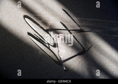 Abstraite de ombres projetées par la lumière du soleil aux lunettes de lecture Banque D'Images