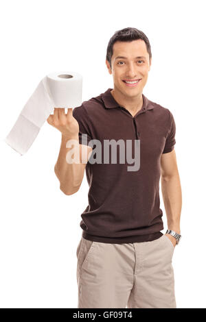 D'un coup vertical cheerful young guy tenant un rouleau de papier de toilette isolé sur fond blanc Banque D'Images