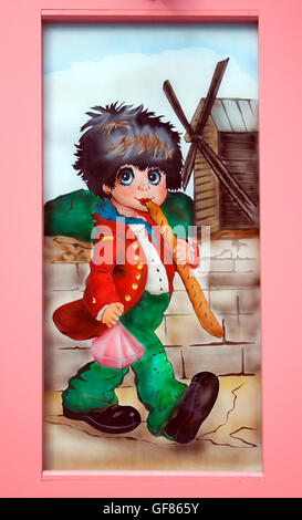 La charmante œuvre « Boy with baguettes » décore une boutique à Montmartre, Paris, ajoutant fantaisie aux rues artistiques du quartier. Banque D'Images