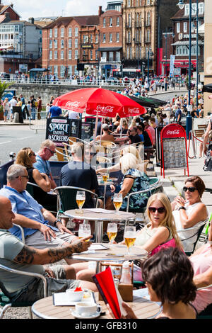 Front de l'Anglais à Ramsgate avec des gens assis à des tables et des chaises à l'ombre des parasols, prendre un verre au cours de temps très chaud en été. Banque D'Images