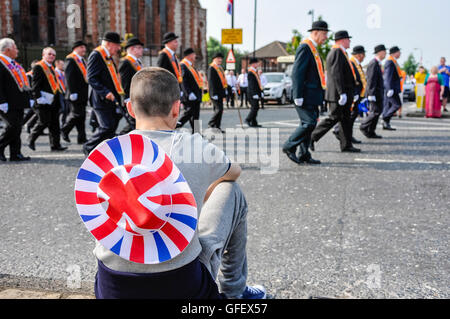 Belfast, Irlande du Nord. 12 juillet 2013 - Un jeune garçon avec un chapeau de cow-boy du pavillon de l'Union européenne observe l'ordre d'Orange défilent Banque D'Images