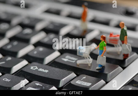 Shoppers miniature avec panier sur un clavier d'ordinateur Banque D'Images