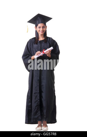 Full Length portrait of female graduate student holding diploma over white background Banque D'Images