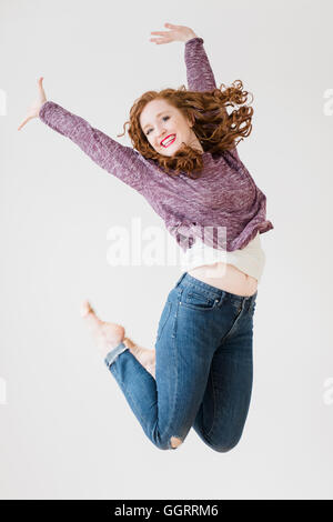 Caucasian woman jumping for joy Banque D'Images