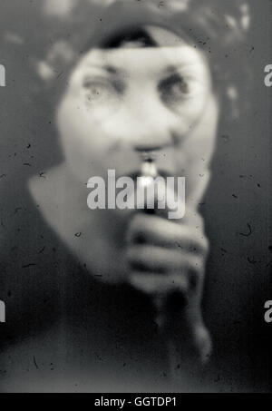 Close up of young woman looking loupe Banque D'Images