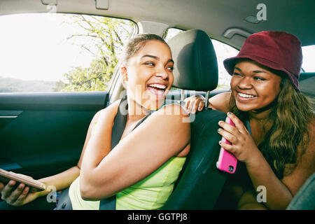 Mixed Race girl laughing in car Banque D'Images