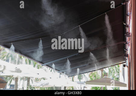 L'eau vaporisée éclaboussures sprinkleurs auvent terrasse au bar afin de refroidir la température de l'été en Espagne Banque D'Images