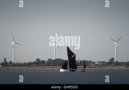 West Mersea, Essex, Royaume-Uni. 9 août 2016. Météo France : une barge de la Tamise voiles cours des éoliennes de Bradwell sur la rivière Blackwater, tôt ce matin. Crédit : Andrew O'Brien/Alamy Live News Banque D'Images