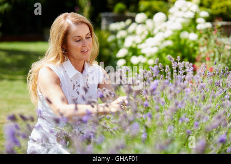 Femme fleurs de fraisage extérieur Banque D'Images