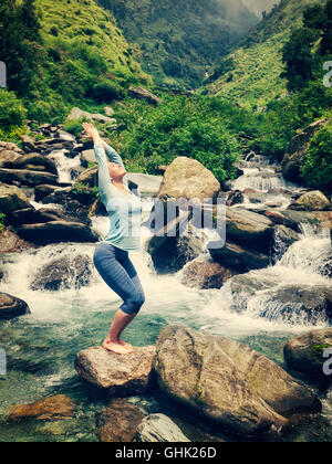 Larry mullen fit woman doing yoga asana Utkatasana outdoors Banque D'Images