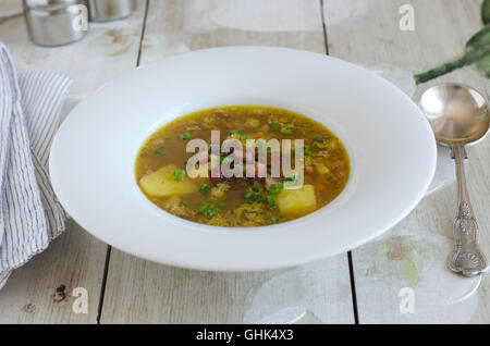 Soupe de lentilles et lard surmontée de ciboulette Banque D'Images