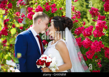 Couple de mariage dans les fleurs à l'heure d'été Banque D'Images