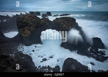 Une tempête hivernale sur la côte près de Arnastapi (rock arch de Gatklettur), Péninsule Snaefellsness, Islande Banque D'Images