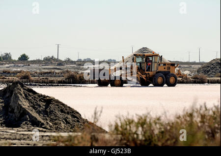 Le sel de mer d'exploitation du site d'Aigues-Mortes salins avec de grosses machines et de camions travaillant pour le stockage du sel Banque D'Images