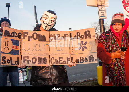 Chicago, Illinois - 29 novembre 2013 : un homme portant un masque anonyme manifestations devant un magasin Walmart à l'appui des grévistes le vendredi noir. Banque D'Images