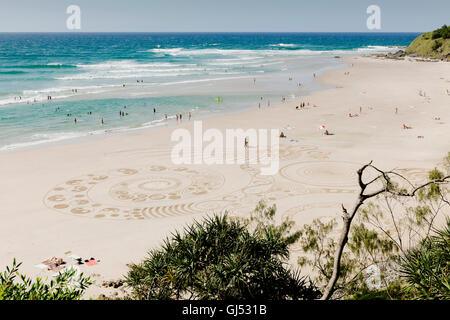 Des dessins dans le sable à la plage de Wategos à Byron Bay. Banque D'Images