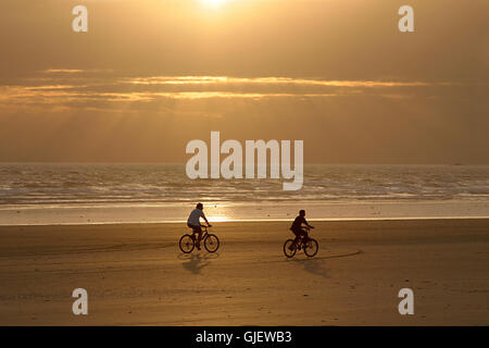 Les cyclistes sur la plage Banque D'Images