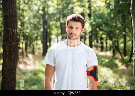 Portrait de beau jeune homme sportif avec handband à forest Banque D'Images
