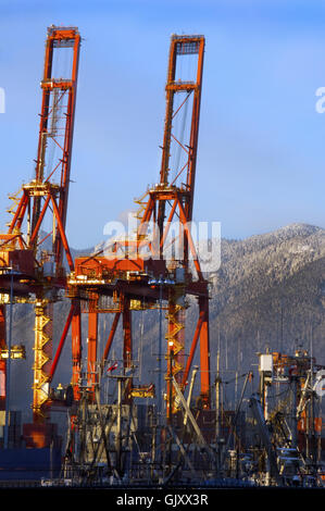 Deux portiques situés à Centerm Port à Vancouver's Burrard Inlet avec beaucoup de Grouse Mountain et Ciel Bleu profond Banque D'Images