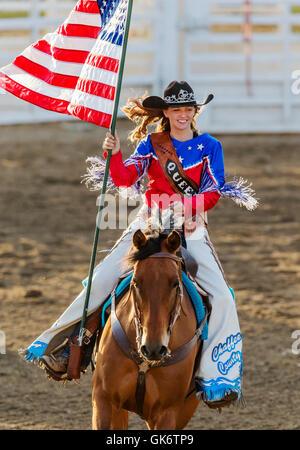 La Reine du rodéo à cheval avec le drapeau américain ; Chaffee County Fair & Rodeo, Salida, Colorado, USA Banque D'Images