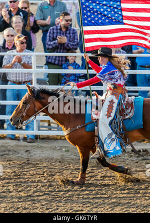 La Reine du rodéo à cheval avec le drapeau américain ; Chaffee County Fair & Rodeo, Salida, Colorado, USA Banque D'Images