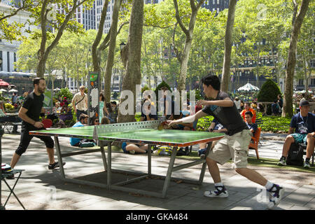 Un couple de joueurs de tennis de grave aller à elle au gratuit tables de Bryant Park le long de la 42e Rue à Midtown Manhattan, New York. Banque D'Images