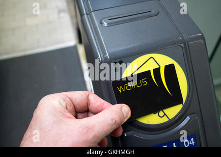 L'homme à l'aide d'une carte sans contact morse merseytravel smartcard voyage à la gare porte d'entrée à Liverpool Banque D'Images