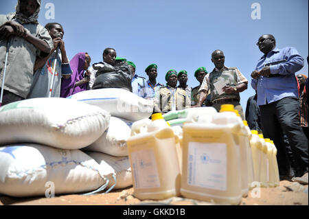 Officier de liaison humanitaire Senior, Abdul Diabagate, livre un petit discours au cours d'un document de l'alimentation à un camp de personnes déplacées, Siliga Amerikanka, le 24 février 2014. Un groupe d'agents de police individuels l'AMISOM recueillis l'argent entre eux et ont acheté des denrées alimentaires pour une communauté de 50 personnes aveugles. La communauté a reçu 10 sacs de riz, 3 sacs de maïs, 3 sacs de niébé, 3 sacs de sucre, de sel et de 20 gallons d'huile. Banque D'Images