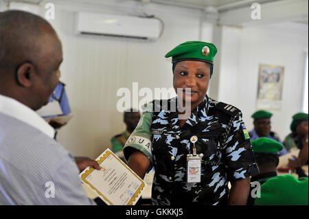 ACP Crowd Chirenje remet un certificat à un officier nigérian lors d'une cérémonie d'adieu à Mogadiscio le 12 juillet 2015. La cérémonie a marqué la fin d'une année de service de l'unité de police constituée nigériane dans le cadre de l'AMISOM. Banque D'Images