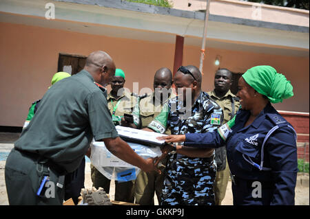 Des policiers de l'AMISOM font don de matériel de bureau au commandant Hussein Mohamed Abdi, commandant de la police du district de Hodan, à Mogadiscio, le 15 novembre 2015. Le don comprenait un ordinateur de bureau, une imprimante et de la papeterie pour soutenir les forces de l'ordre locales. Banque D'Images