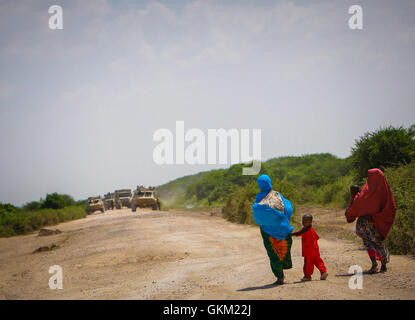 La Somalie, le Moyen-shabelle : Dans un document de cours photographie prise le 10 décembre et publié par l'Union africaine et l'équipe de support d'information des Nations Unies 12 décembre, les femmes somaliennes et leurs jeunes enfants à pied le long de la route à mi-distance entre les villes de Balcad Jawahar et dans la région du Moyen-Shabelle au nord de la capitale Mogadishu. L'armée nationale somalienne (SNA) force appuyée par la Mission de l'Union africaine en Somalie (AMISOM) a capturé la ville de Jawahar, 90km au nord de Mogadiscio, le 9 décembre de l'Al-Qaeda groupe extrémiste affiliés à Al Chabaab rencontrer peu de résistance alors qu'ils entraient dans le Banque D'Images