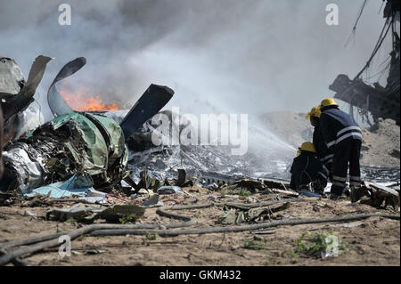 Les pompiers de l'AMISOM répondent à un accident d'avion de l'armée de l'air éthiopienne à l'aéroport international d'Aden Adde, à Mogadiscio, le 9 août. Deux des six membres d'équipage ont survécu. Les pompiers ont travaillé pour contenir l'incendie causé par l'accident. / Au-un IST photo / Tobin Jones Banque D'Images