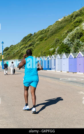 Bournemouth, Dorset, UK 23 août 2016. Runner jogging le long de la promenade du cours des cabanes de plage à la plage de Bournemouth un jour ensoleillé chaud Crédit : Carolyn Jenkins/Alamy Live News Banque D'Images