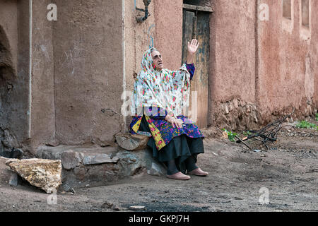 Soghra est un Abyanaki femme dont la famille a tous quitté le village. Abyaneh est un village de Barzrud District rural, dans le quartier central de comté de Natanz, Ispahan, Province de l'Iran. Au recensement de 2006, sa population était de 305 160, dans les familles.caractérisé par un étrange teinte rougeâtre, le village est un des plus anciens de l'Iran. Un Abyanaki typiquement femme porte une longue écharpe blanche (couvrant les épaules et le haut du tronc) qui a un motif coloré et d'une sous-jupe au genou. Banque D'Images