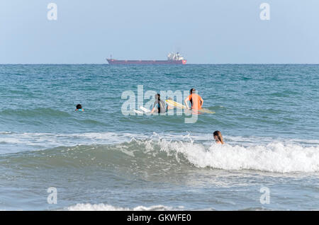 Certains surfeurs essayant d'attraper une vague avec leurs planches, dans la plage de Castellon de la Plana (Espagne) Banque D'Images