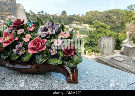 Bouquet de fleurs majolique en céramique sur une tombe dans un cimetière français Banque D'Images