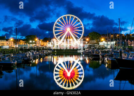 Ballycastle, Co Antrim, en Irlande du Nord, Royaume-Uni. Août 28, 2016. Les habitants et visiteurs de Ballycastle profitez de la météo à aller bon week-end la grande roue et d'autres amusements le soir avant le début de l'Lammas Fair 'l'Ould Lammas Fair' a eu lieu à Ballycastle, Co Antrim, chaque année depuis le XVIIE siècle. Célébré le dernier lundi et mardi d'août, la juste marque la fin de l'été et début de la récolte et est l'une des plus anciennes foires en Irlande. Credit : Eoin McConnell/Alamy Live News Banque D'Images