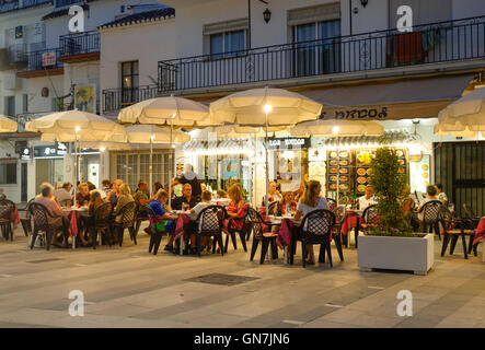 Les gens sur la terrasse illuminée en espagnol village blanc, Mijas, Andalousie, espagne. Banque D'Images