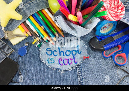 School is Cool signer avec des objets d'apprentissage créatif sur les blue-jeans Banque D'Images