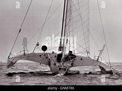 Nouvelles photos d'AJAX. 1976. PLYMOUTH, en Angleterre. - RACE - OSTAR MANQUANT - MIKE MCMULLEN DANS LE TRIMARAN THREE CHEERS AU DÉBUT DE LA COURSE AU LARGE DE PLYMOUTH. Il n'a jamais vu de nouveau. PHOTO:JONATHAN EASTLAND/AJAX REF:2760506 26 Banque D'Images