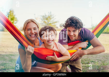 Family relaxing together outdoors, portrait Banque D'Images