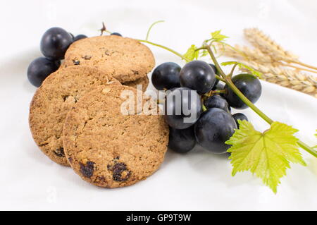 Partie intégrante des cookies avec des raisins et du blé sur blanc Banque D'Images