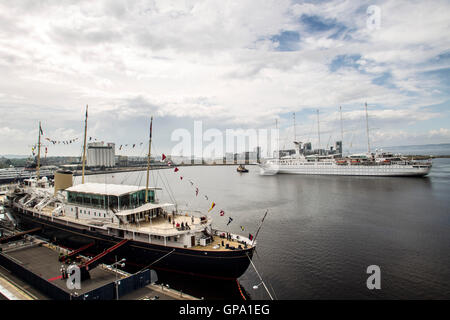 Paquebot de luxe surf vent entrant dans le Port de Leith avec Royal Yacht Britannia en premier plan Banque D'Images