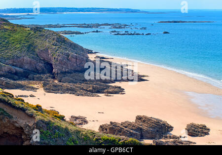 Les roches sombres sur une plage de sable de la côte atlantique à la Côte de Granit Rose en Bretagne, France Banque D'Images