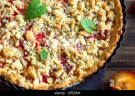 Pâte brisée maison gâteau aux prunes (PIE) à s'écrouler sur fond de bois Banque D'Images