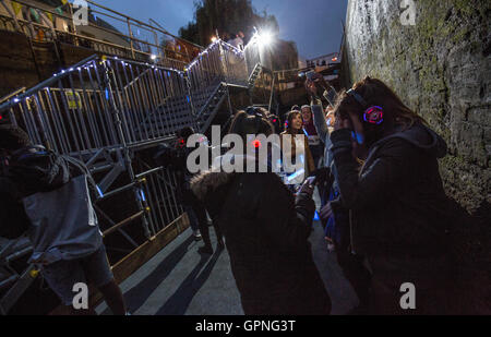 Les gens assistent à une discothèque silencieuse au Camden Locks comme le Canal & River Trust de célébrer la fin d'une période de trois ans et un demi-million de livres Projet de restauration, qui implique le remplacement de huit ensembles de portes, Regents Canal, Londres. Banque D'Images