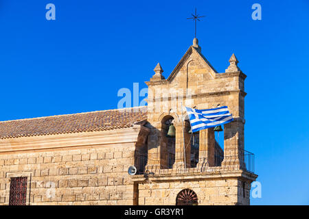 En agitant le drapeau grec sur le clocher de l'église Saint Nicholas Molou sur place Solomos. Zakynthos, île grecque dans la mer Ionienne Banque D'Images