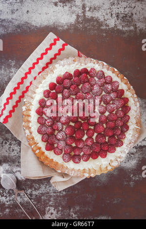 Tarte aux framboises avec crème à la vanille et le sucre glace. Macro, selective focus, tons vintage image, espace blanc Banque D'Images