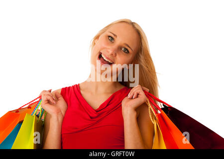 Belle jeune femme avec des sacs de magasinage le consumérisme isolated over white backgeeound Banque D'Images