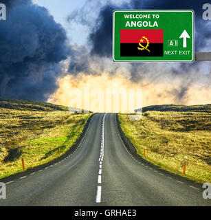 Angola road sign against clear blue sky Banque D'Images